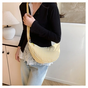 Detail of yellow checkered canvas dumpling bag with adjustable shoulder strap for women