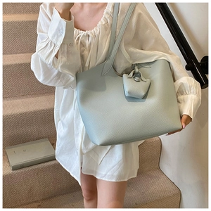 Close-up of light blue large tote bag in lychee grain leather with matching pouch