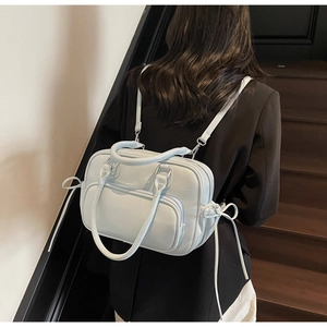 Rear view of a light blue multi-functional backpack on model with side bow details