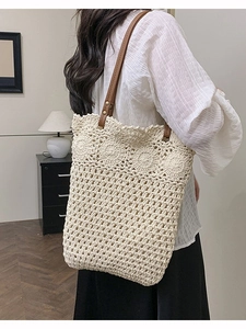 Bohemian crochet hobo bag with floral patterns and brown leather shoulder strap