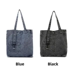 Detail view of blue and black vintage washed denim tote bags with metal D-rings