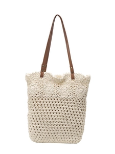Off-white crochet tote bag with floral cutout patterns and brown leather shoulder straps
