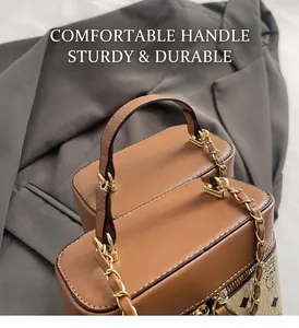 Detail of a brown leather crossbody bag with golden hardware and monogram print