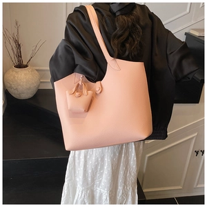 Detail of pink large tote bag with textured faux leather and matching mini coin purse