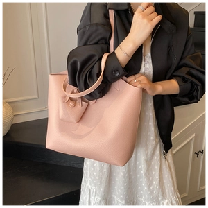 Pink large capacity faux leather tote bag with pebble grain texture and matching coin purse