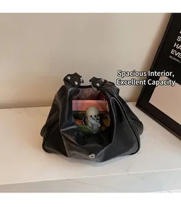 Detail view of black vintage dumpling bag interior showing large capacity for essentials