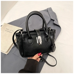 Close-up of black lychee texture bucket bag with silver metal swivel lock and handle