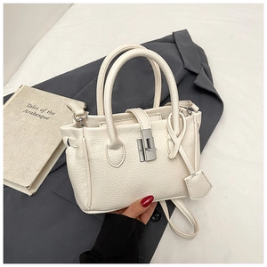Close-up of white lychee pattern leather bucket bag with silver metal twist lock hardware