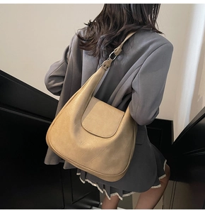 Close-up of khaki retro hobo bag showing textured PU leather and silver metal buckles