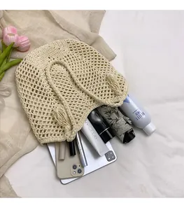Macro detail of beige crochet tote bag showing hollow knit texture and spacious interior