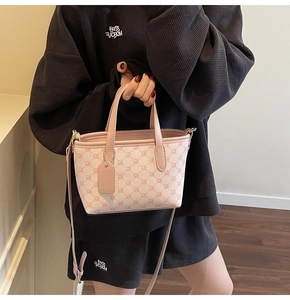 Détail du sac seau bicolore rose et beige avec imprimés et bandoulière amovible