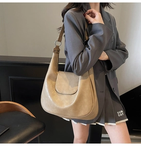 Khaki large hobo shoulder bag with metal ring hardware styled for daily commute outfit
