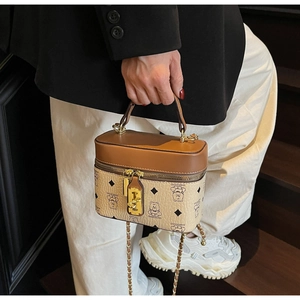 Detailed shot of retro bucket bag with bear print, gold hardware and chain strap