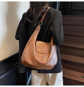 Brown vintage hobo bag details showing textured PU leather and silver metal ring hardware