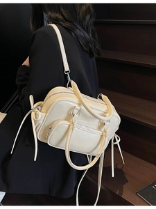 Creamy white fashion backpack and handbag for women shown from a stylish side view angle