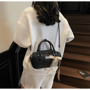 Borsa Boston nera intrecciata a tracolla con ciondolo a fiocco in pizzo elegante