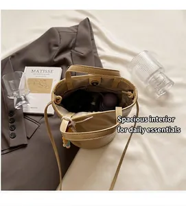 Bovenaanzicht van beige bucket bag met magnetische sluiting en binnenzak met rits
