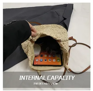 Interior view of large straw beach bucket bag holding a tablet and cosmetics