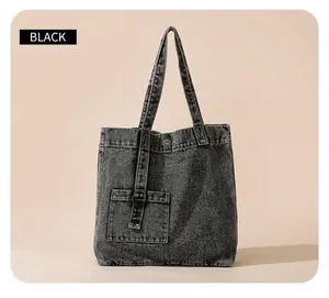 Close-up of vintage dark gray denim tote bag with functional pocket and metal D-ring details