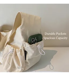 Detail view of the functional side drawstring pocket on a creamy white tote bag