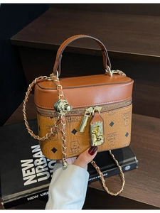 Vintage brown cylinder bucket bag with bear print and golden chain strap detail