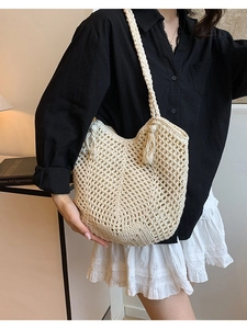 Hollow out straw tote bag with tassels and woven shoulder strap for beach vacation