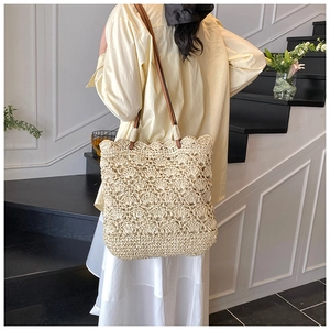 Detail of hand-woven crochet tote bag with wave texture and brown leather shoulder straps