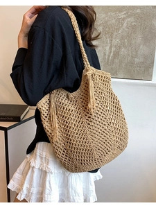 Handmade woven straw tote bag with hollow grid patterns and elegant tassel details