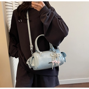 Selfie allo specchio con borsa Boston azzurra in vernice e ciondolo fiocco di perle