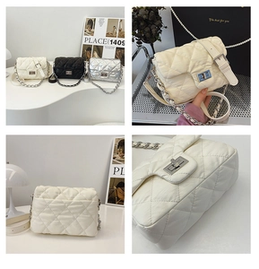 Detail of quilted crossbody bags in black white and silver with metal chain strap