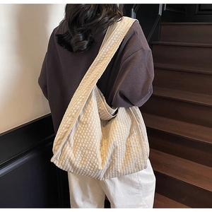 Detail of checkered canvas tote bag showing the soft texture and spacious gingham design