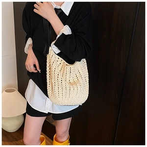 Close-up of cream woven knit tote bag showing intricate crochet geometric patterns