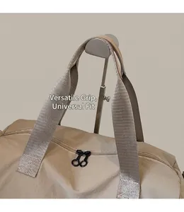 Close-up of beige large travel bag showing durable woven handles and double zippers