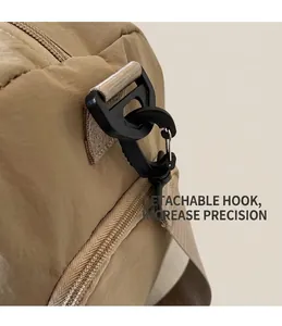 Detail of detachable rotating hook on khaki nylon multi-function travel shoulder bag