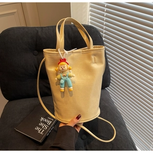 Detail of cream beige bucket bag showing wrinkled faux leather texture and FASHION stamp