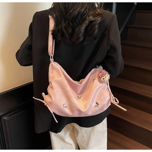 Detailed view of large pink pleated crossbody bag featuring silver butterfly sequins