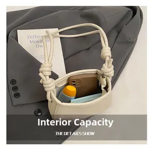 Detail view of cream pebble leather shoulder bag showing inner capacity for essentials