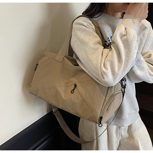 Detailed view of the khaki travel bag with nylon texture and adjustable shoulder strap