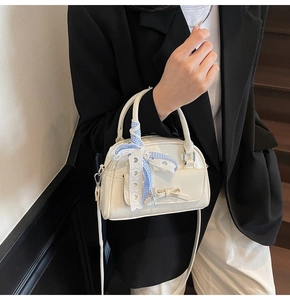 Chic cream white crossbody bag with decorative bow and elegant checkered scarf detail