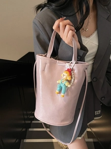Chic pink glossy bucket bag with crinkle texture and cute cartoon doll pearl keychain