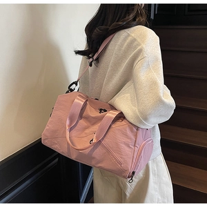 Detailed side view of large pink multifunctional travel bag with shoulder strap