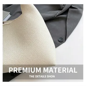 Close-up of creamy white lychee grain leather texture on minimalist shoulder bag