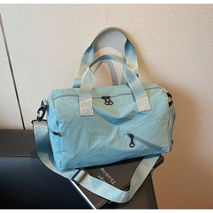Detail of mint green waterproof travel bag with double-way zippers and side pocket