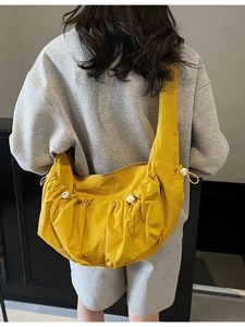 Yellow large capacity nylon dumpling crossbody bag with adjustable drawstring design