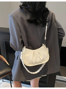 Chic cream dumpling shoulder bag with woven strap shown from a back perspective