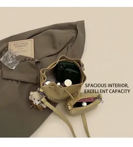 Internal view of litchi texture bucket bag showing spacious storage for phones and makeup