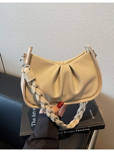 Beige pleated hobo bag with braided strap on book, minimalist crossbody purse for women