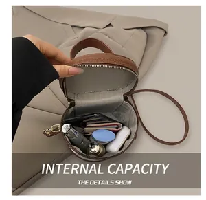 Interior view of small brown pebbled leather bucket bag showing everyday storage capacity