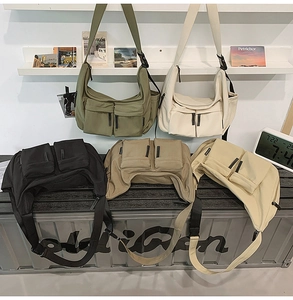 Detailed display of five color options for large nylon crossbody bags with multi-pockets