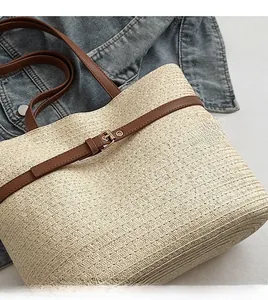 Close-up of natural woven straw texture with brown leather straps and metal buckle